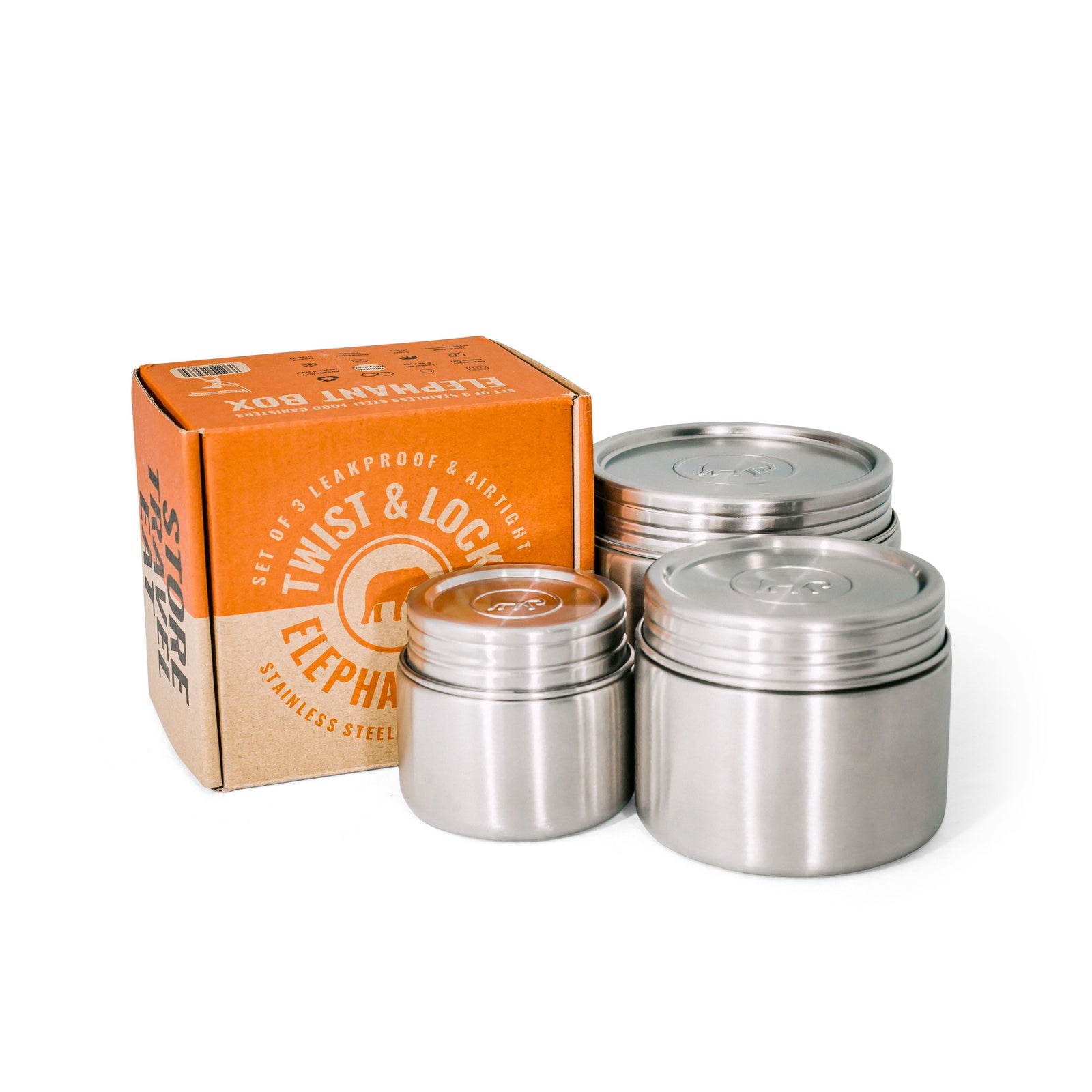 Three brushed steel food canisters of varying sizes with their lids on, displayed in front of an orange and white product box with Elephant Box branding text.