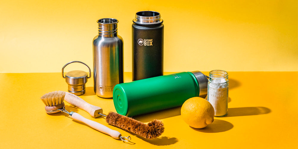 A selection of reusable water bottles and plastic free cleaning utensils