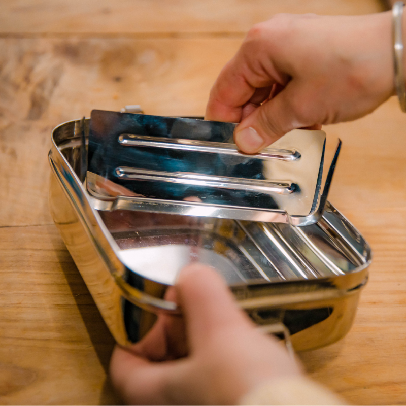 hand holding stainless steel divider to fit the jumbo 2 in 1 and elephant box