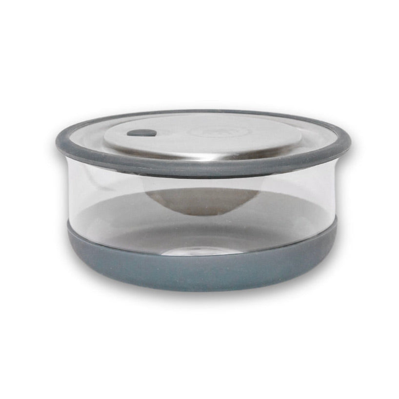 An Elephant Box borosilicate glass lunch bowl with a grey silicone sleeve and stainless steel lid. the lunch bowl features a vacuum tab for an airtight leakproof seal. 