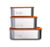 A set of three Elephant Box stainless steel  food storage containers with borosilicate glass lids, stacked from largest to smallest. The leakproof silicone vacuum seal and tab is orange in colour