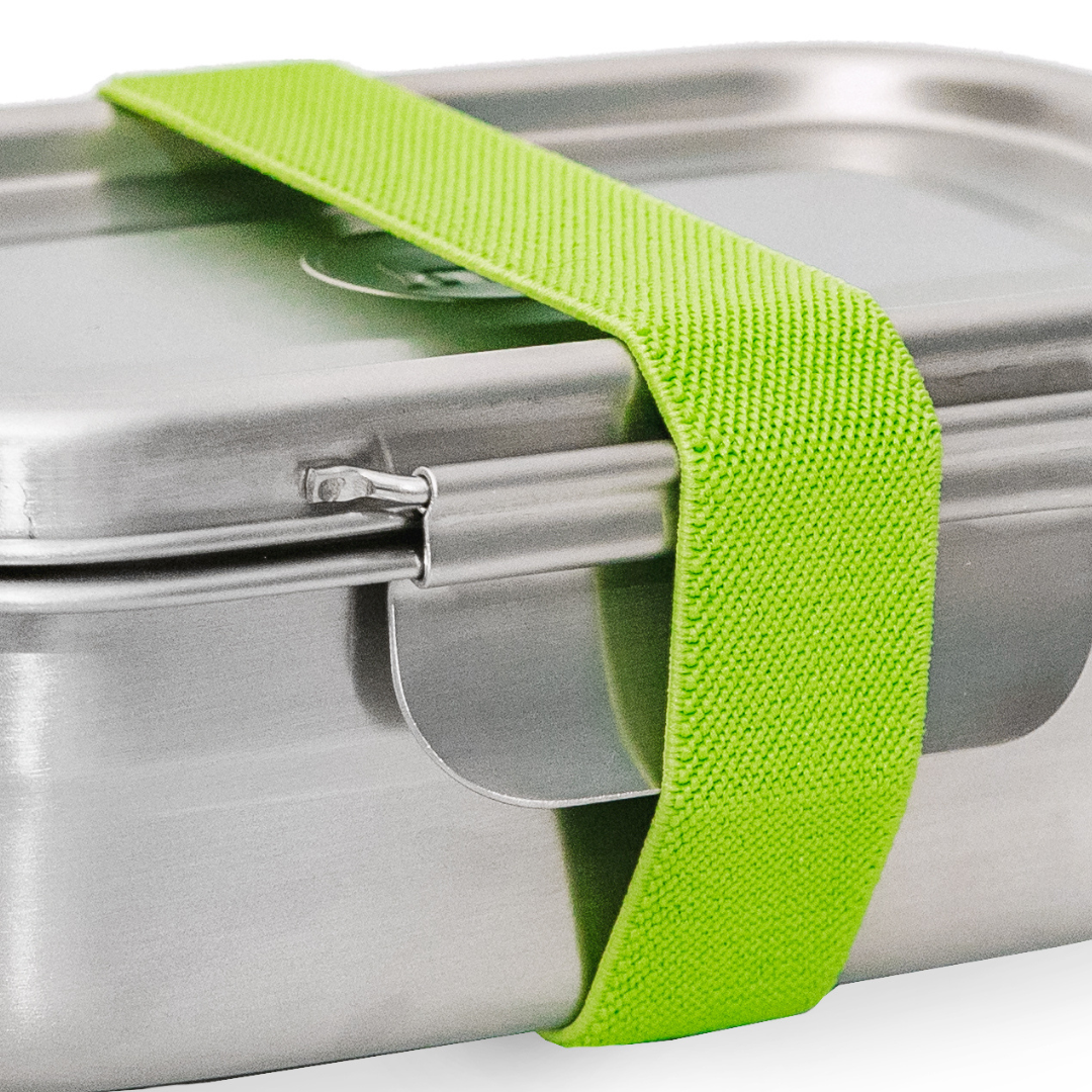 A stretchy green band placed on a rectangular clip and seal metal lunch box. 