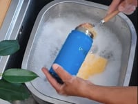 demo of the wooden washing up brush washing one of our insulated flasks