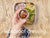 this video demonstrates what fits into our square salad box. it is a birdseye view of the box. you can only see the box and the persons hands! the hands put a falafel wrap into the box then it cuts straight to another filling idea of some noodles. the noodles are already dressed with herbs, seaweed, seeds, onion and coriander. this time there is also a dressing pot with some sauce in it (mango chutney). the dressing pot also fits into the salad box.