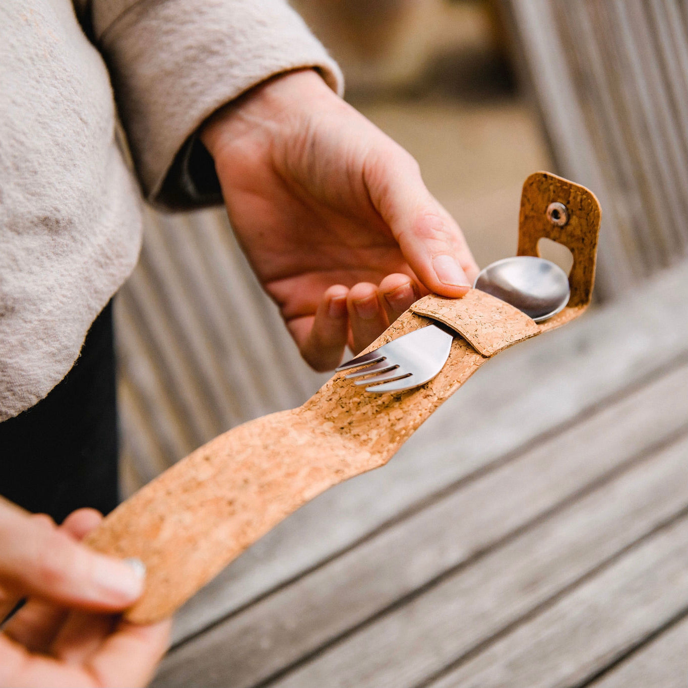 A stainless steel spork with a spoon on one end and a fork on the other, with a elephant box  logo in the centre.