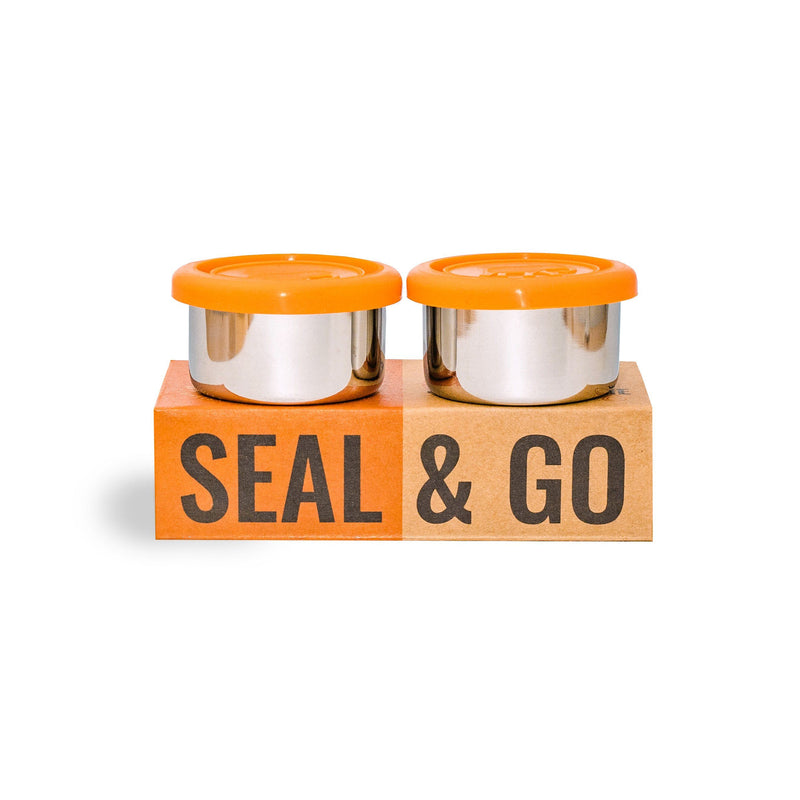 Two elephant box stainless steel dressing pots with orange silicone lids featuring cardboard packaging that has the text 'SEAL & GO' printed on it.