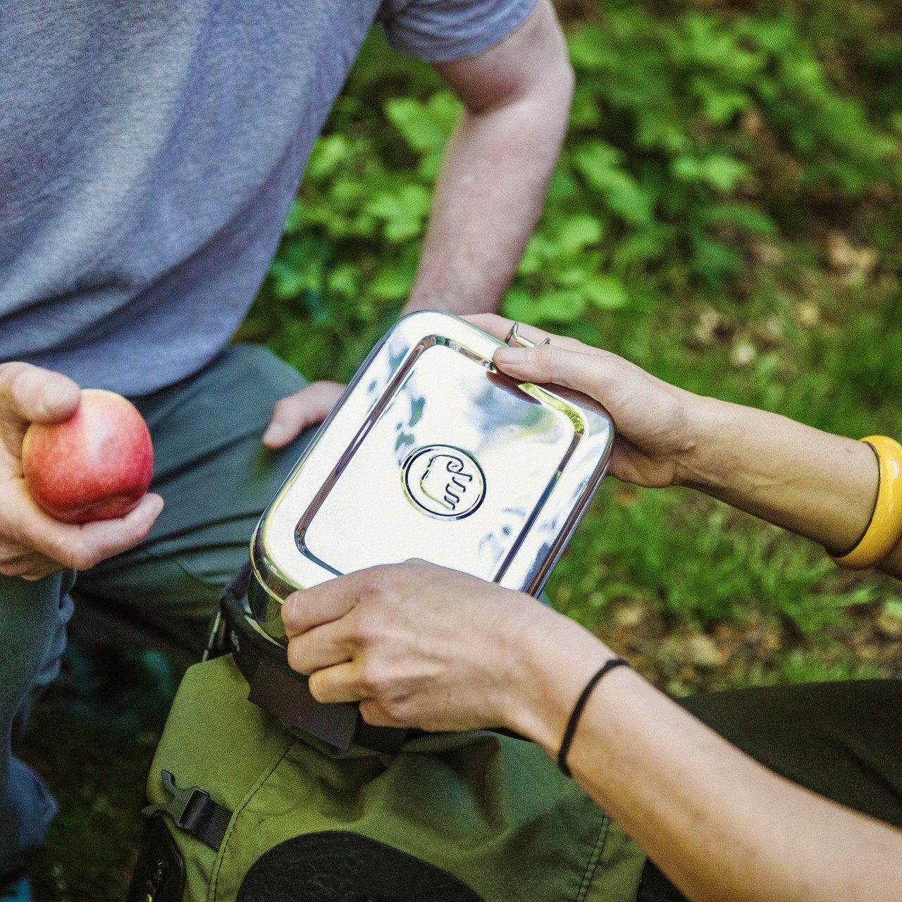 Couple with Elephant Box picnic lunch box. One person holding large steel lunch carrier  