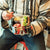 Man eating lunch out of large metal lunchbox using a spork Elephant Box