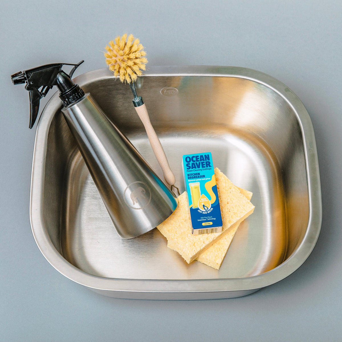 Plastic Free Kitchen Kit Elephant Box which includes a metal washing basin, eco-friendly cleaning items a wooden dish brush and a reusable spray bottle 